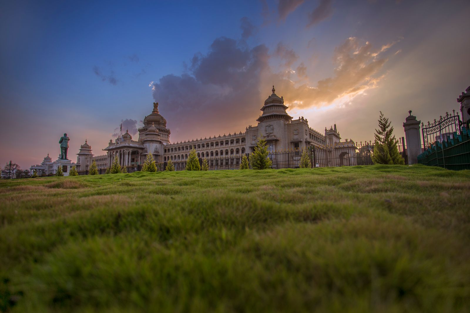 Vidhana Soudha in Bangalore at golden hour behind green lawns